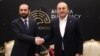 Turkish Foreign Minister Mavlut Cavusoglu (right) shakes hands with Armenian Foreign Minister Ararat Mirzoian in Antalya on March 12.