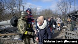 People evacuate from Irpin, near Kyiv, as Russia's invasion of Ukraine continues, March 9, 2022.