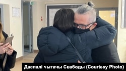 Belarusian businessman Alyaksander Vasilevich is hugged by a supporter after leaving the courtroom in Minsk on February 4. 