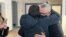 Belarusian businessman Alyaksander Vasilevich is hugged by a supporter after leaving the courtroom in Minsk on February 4. 