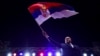 Bosnian Serb leader Milorad Dodik waves the Serbian flag to thousands who gathered in Banja Luka, Bosnia, on October 25.