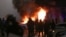 Горящий полицейский автомобиль во время январских протестов из-за повышения цен на газ в Алматы 5 января 2022 года.