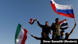 Орусиянын, Ирандын, Сириянын желегин көтөргөндөрдүн Дамасктагы нааразылыгы. 14-апрель, 2018-жыл.