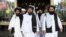 Members of a Taliban delegation, led by chief negotiator Mullah Abdul Ghani Baradar (center, front), leave after peace talks with senior Afghan politicians in Moscow on May 30.
