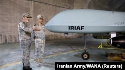Iran's then-army chief, Abdolrahim Mousavi (left), and slain armed forces chief of staff, Mohammad Baqeri, visit an underground site with drones at an undisclosed location in Iran in 2022.