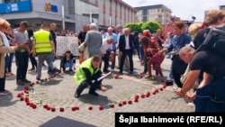 Victims' families and activists marked the anniversary by wearing white ribbons and gathering to lay red roses on the central square. 