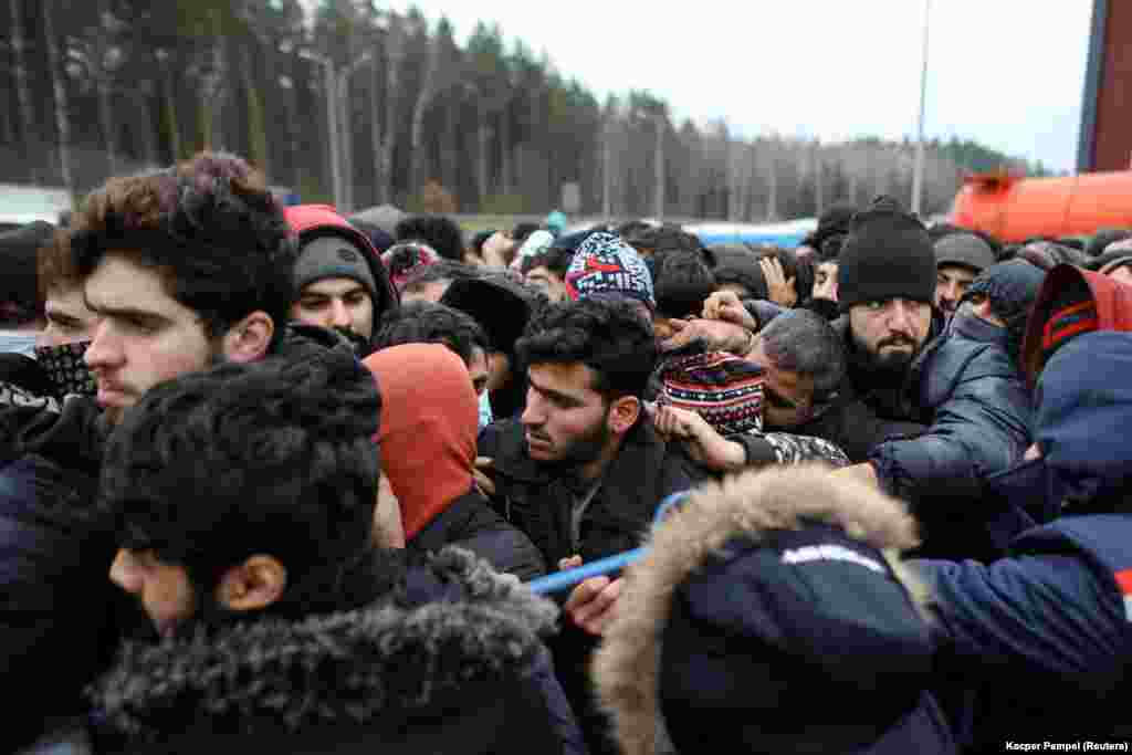 Migrants jostle as they wait to receive food in Belarus.&nbsp;Polish Prime Minister Mateusz Morawiecki on November 21 said that Belarusian leader Alyaksandr Lukashenka had launched a &quot;hybrid war&quot; against the European Union.