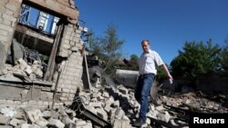 Чоловік біля зруйнованого російськими обстрілами будинку в Харкові, 7 червня 2022 року