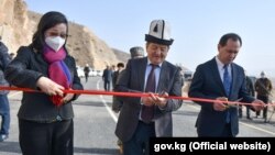 The chairman of the Kyrgyz Cabinet of Ministers, Akylbek Japarov (center), and Chinese Ambassador to Kyrgyzstan Du Dawen (left) open a bridge on November 11 to mark the completion of part of a highway project, just one of many infrastructure ventures in the region that receive support from Beijing. 