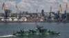 A Russian Navy ship passes the cargo seaport of Mariupol, an occupied Ukrainian city on the Sea of Azov, in June 2022. 