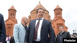 Armenia - Businessman Gagik Tsarukian is seen against the backdrop of the newly built Surp Hovannes church built by him in Abovian, 14May2013.