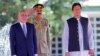 Afghan President Ashraf Ghani (left) and Pakistani Prime Minister Imran Khan (right) review an honor guard during a welcoming ceremony in Islamabad on June 27. 