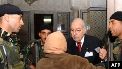 یک زن تونسی در حال دیدار با فواد المبزع، رئیس‌جمهور موقت