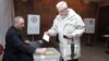 Armenia - A man votes in a presidential election at a polling station in Yerevan, 18Feb2013.