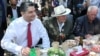 Armenia -- Prime Minister Tigran Sarkisian (L) shares meal with World War II veterans in Yerevan's Victory Park, 9May2012.