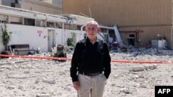 Israeli Prime Minister Benjamin Netanyahu stands amid debris outside the Soroka Hospital in the southern city of Beersheba, after it was hit by a missile fired from Iran on June 19, 2025.