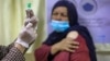 A medical worker prepares a dose of the Indian version of the AstraZeneca coronavirus vaccine at a hospital in Kabul.