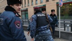 Armenia -- Armed policemen rush to Erebuni Plaza Business Center where a gunman opened fire, Yerevan, January 23, 2020.