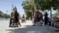 Taliban fighters patrol inside the city of Ghazni, southwest of Kabul, on August 12.