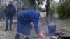 Civilians with no access to gas or electricity build a fire in Kostyantynivka.