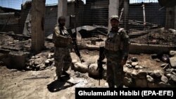 Afghan security forces patrol a village after they cleared the area of Taliban militants in the Achin district of the Nangarhar Province on May 31.