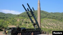 Офіційне фото північнокорейського агентства ЦТАК: ракета «Хвасон-14» на стартовій позиції (лідер країни Кім Чон Ин – унизу праворуч біля ракети, в чорному костюмі)