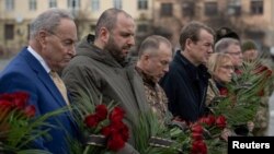 U.S. Senate Majority Leader Chuck Schumer, Ukrainian Defense Minister Rustem Umerov, Chief of the Ukrainian Armed Forces Colonel General Oleksandr Syrskiy, and Senators Michael Bennet and Maggie Hassan visit the Cemetery of the Defenders in Lviv, Ukraine, on February 23.