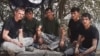 A screen grab from a video posted on an Islamist website, in which five men pledge allegiance to the extremist group. At least one of them resembles one of three suspects whose photographs were released by Tajik authorities in connection with a deadly attack on foreign cyclists on July 29. 