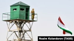 A Tajik border patrol officer stands on an observation tower at the Somon border outpost. (file photo)