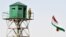 A Tajik border patrol officer stands on an observation tower at the Somon border outpost. (file photo)