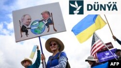 Demonstrantlar ABŞ we rus prezidentleriniň duşuşygynyň öňüsyrasynda, 14-nji awgustda Ukraina goldaw bildirip, Alýaska ştatynyň Ankoridž şäherinddki Seward magistral ýolunyň ugrunda baýdak göterýär. 