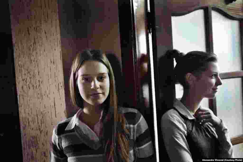 Yulia and Yulia, who are 14 and 15 years old, wait between classes.