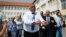 Former Bulgarian Prime Minister Boyko Borisov leaves a polling station after casting his ballot during the snap parliamentary and European Parliament elections at a polling station in Sofia on June 9.