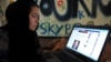 An Afghan woman browses Facebook at an Internet cafe in Kabul before the Taliban takeover in 2021. 