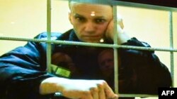Aleksei Navalny appears on a screen set up in a Moscow courtroom in May 2022.
