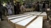 The coffins of the victims of the June 8 attack are placed on the ground at a hospital in northern Baghlan Province on June 9.
