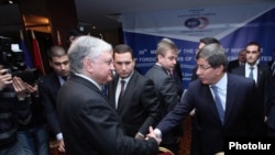 Главы МИД Армении и Турции - Эдвард Налбандян (слева) и Ахмет Давутоглу приветствуют друг друга в отеле «Армения Марриот», Ереван, 12 декабря 2013 г.