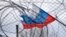 Generic – The flag of Russia on the background of the fence and barbed wire