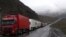 Georgia - Armenian and other heavy trucks are lined up on a road leading to the Georgian-Russian border crossing at Upper Lars, 6May2016.