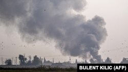 SYRIA -- Smoke rises from the Syrian town of Tel Abyad after Turkish bombings, in a picture taken from the Turkish side of the border near Akcakale in the Sanliurfa province on October 9, 2019.