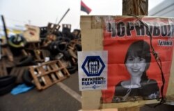 Революція гідності, Київ, 27 грудня 2013 року. Плакат із зображенням журналістки та активістки Тетяни Чорновол, яку жорстоко побили після нападу на неї