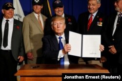Дональд Трамп тримає указ «Державний план дій з підтримки ветеранів і припинення самогубств серед ветеранів», 5 березня 2019 року