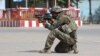 An Afghan National Army commando aims his weapon amid ongoing fighting between Taliban militants and Afghan security forces in Kunduz. 