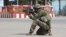 An Afghan National Army commando aims his weapon amid ongoing fighting between Taliban militants and Afghan security forces in Kunduz. 