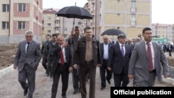 Armenia - Prime Minister Tigran Sarkisian (C) inspects apartment blocks constructed in Gyumri, 26May2012.