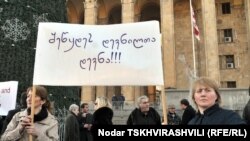 Очередная акция протеста беженцев состоялась сегодня перед зданием парламента Грузии. "Прекратите преследование беженцев" - надпись на транспаранте.