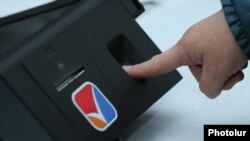 Armenia - An electronic authentication device takes a voter's fingerprints at a polling station in Yerevan, 2Apr2017.
