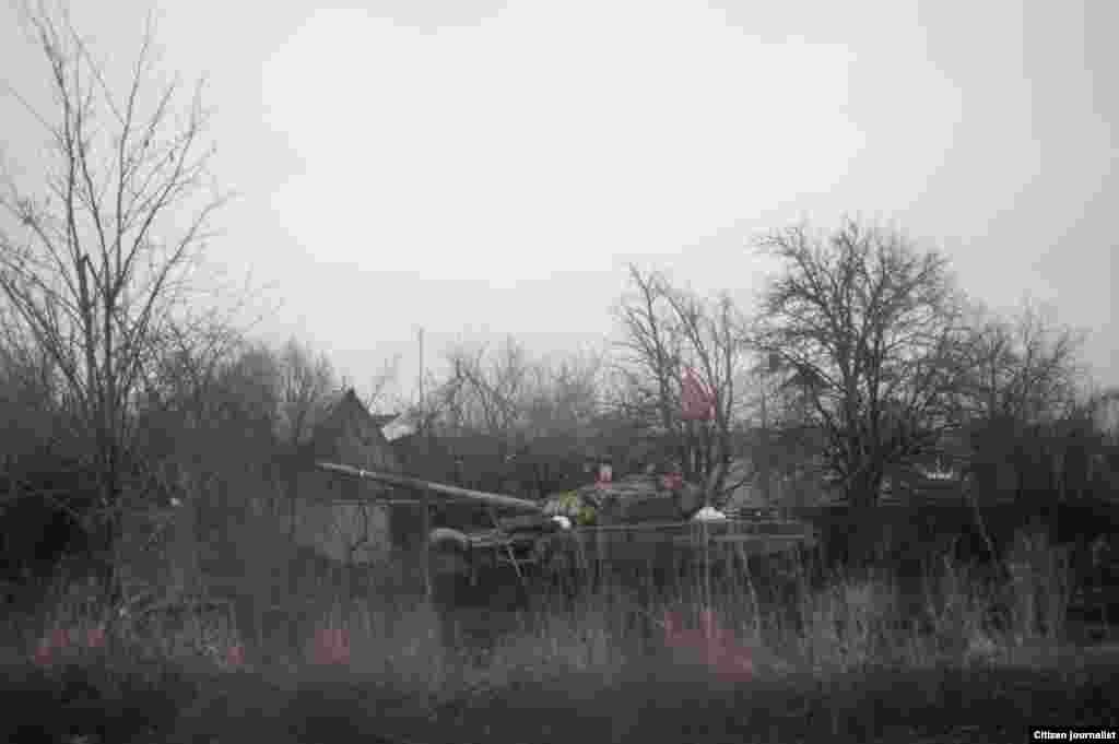 Uglegorsk township, Donetsk region, Ukrain, the territory is controlled bu rebellious Donetsk people republic. There is burned rebels tank by the road.