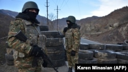 NAGORNO-KARABAKH -- Armenian soldiers stand guard at a checkpoint near the village of Charektar, November 25, 2020