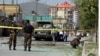Security forces and medical workers attend the scene of a deadly bomb attack in Kabul in June. 